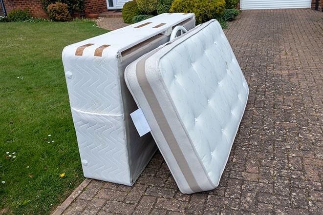 workers clearing out old mattresses for recycling